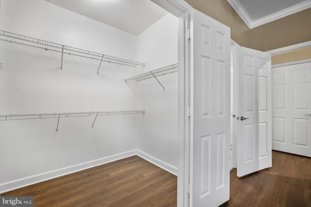 a view of a room with wooden floor