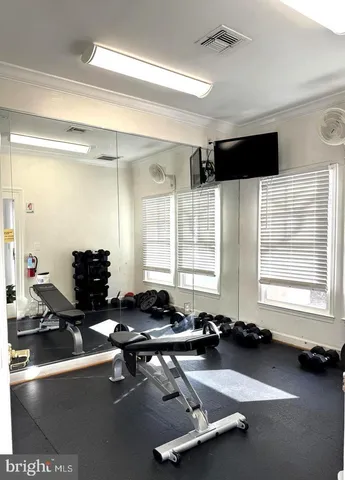 a room with gym equipment and a large window