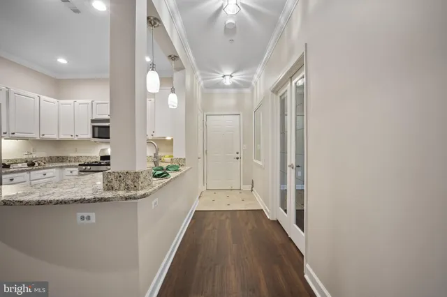 a view of a kitchen with a sink and wooden floor