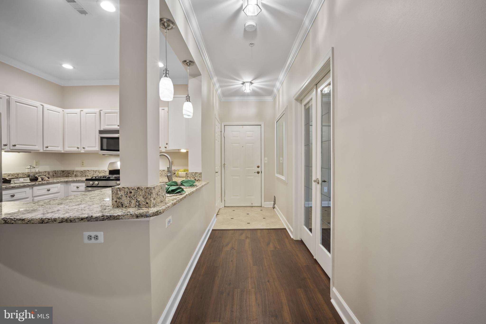 12005 Taliesin Place, Unit 16 Reston, VA 20190 - Photo 7 of 33 a view of a kitchen with a sink and wooden floor