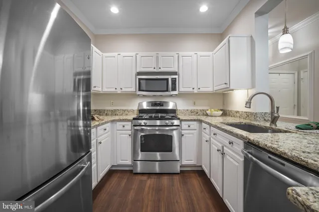 a kitchen with a sink stove and refrigerator