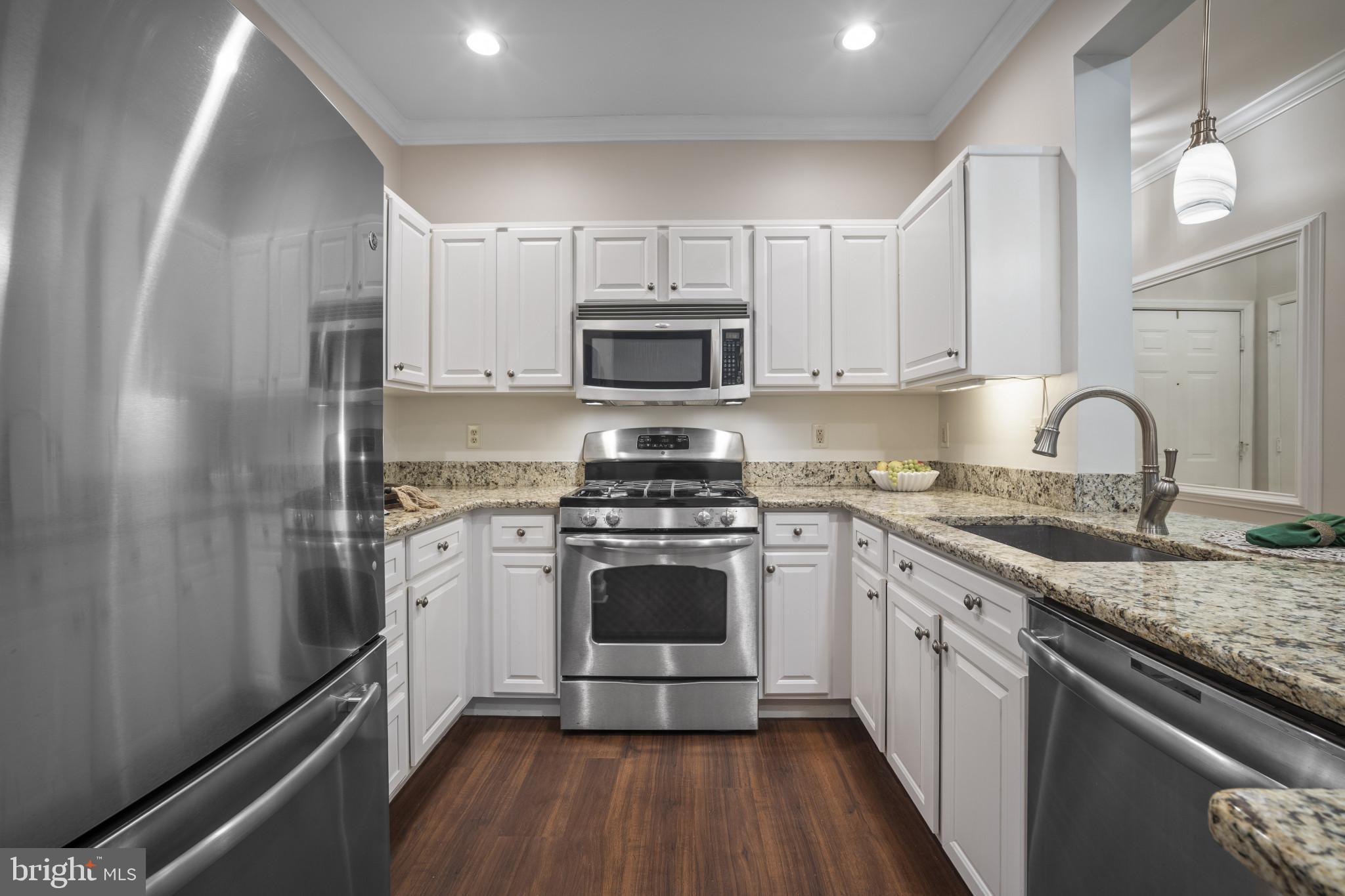 12005 Taliesin Place, Unit 16 Reston, VA 20190 - Photo 8 of 33 a kitchen with a sink stove and refrigerator
