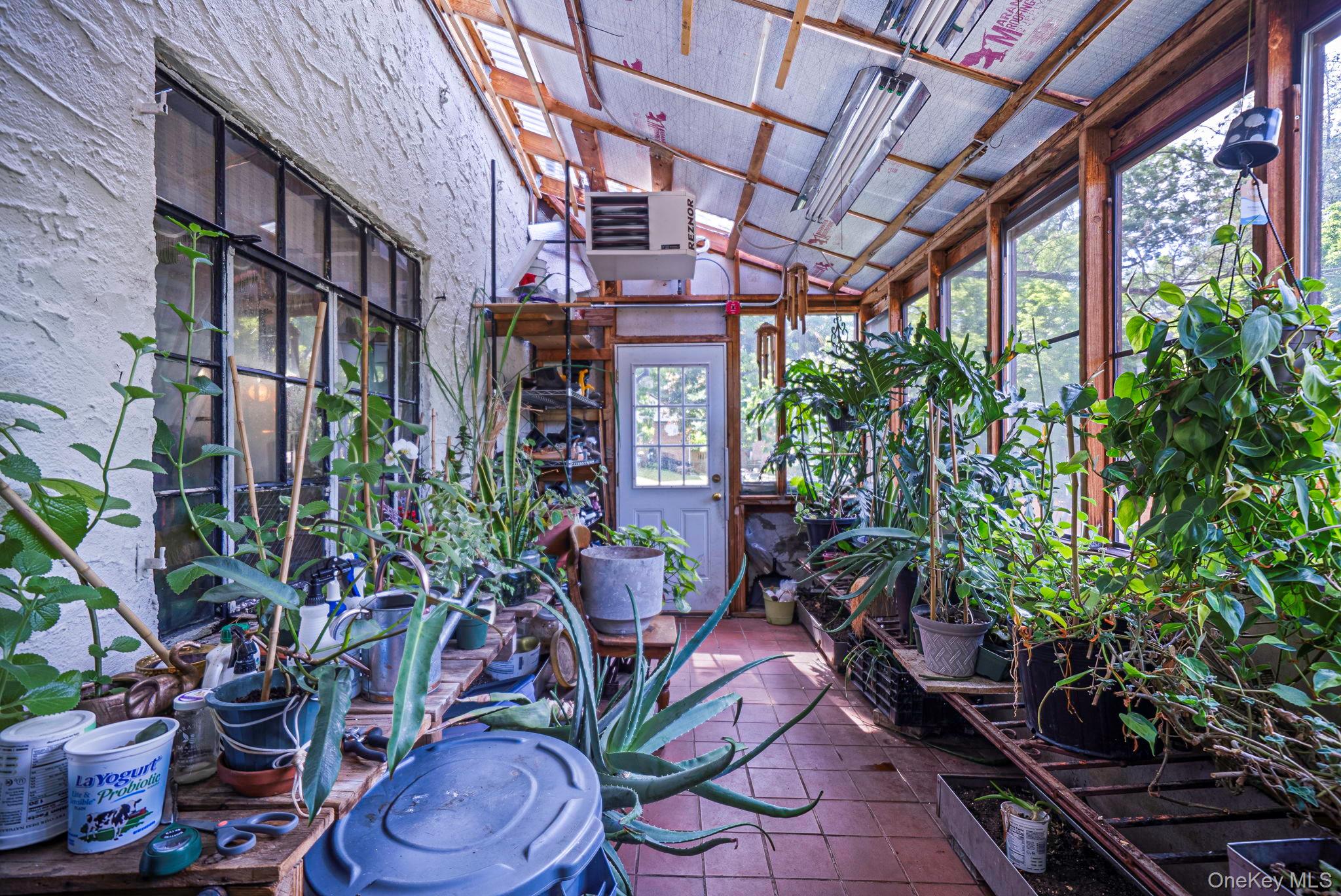 18240 Avon Road Queens, NY 11432 - Photo 6 of 30 Sunroom featuring a tiled floor, exposed wood beam ceiling, and abundant natural light from multiple windows