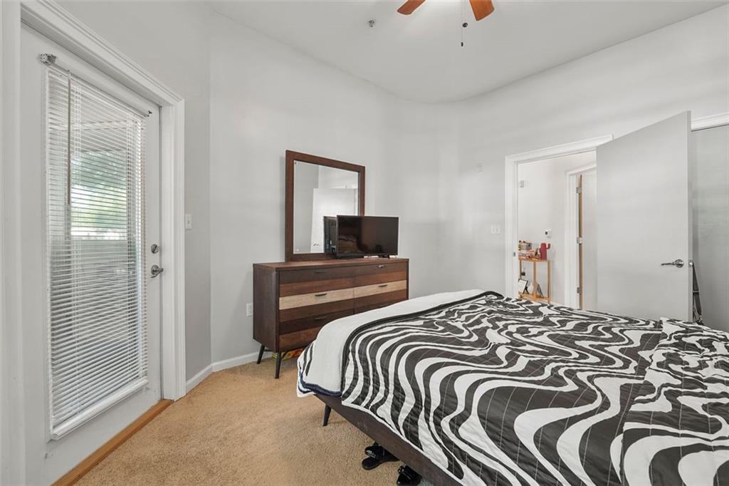 898 Oak Street Southwest, Unit 1105 Atlanta, GA 30310 - Photo 13 of 20 a bedroom with a bed and a chandelier