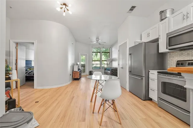 a kitchen with stainless steel appliances a refrigerator stove and microwave