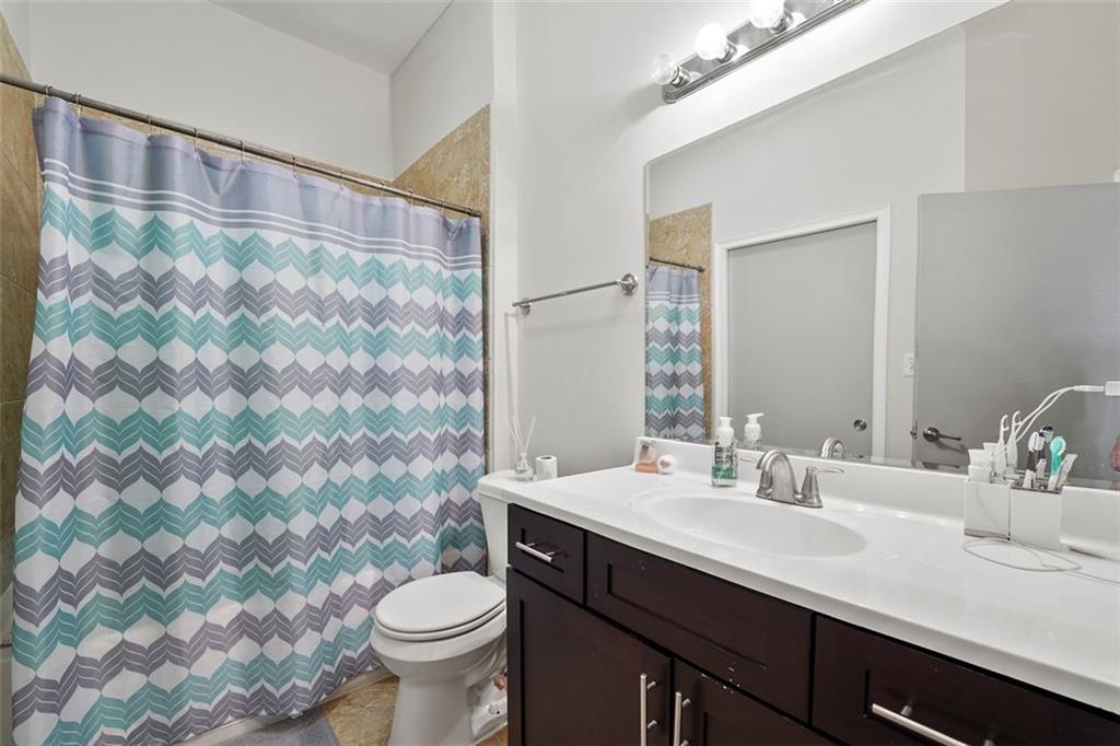 898 Oak Street Southwest, Unit 1105 Atlanta, GA 30310 - Photo 9 of 20 a bathroom with a sink and a mirror