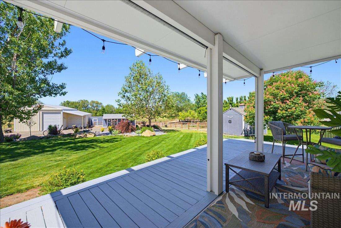 24623 Falcon Lane Caldwell, ID 83607 - Photo 24 of 40 Covered patio featuring a composite deck and string lighting