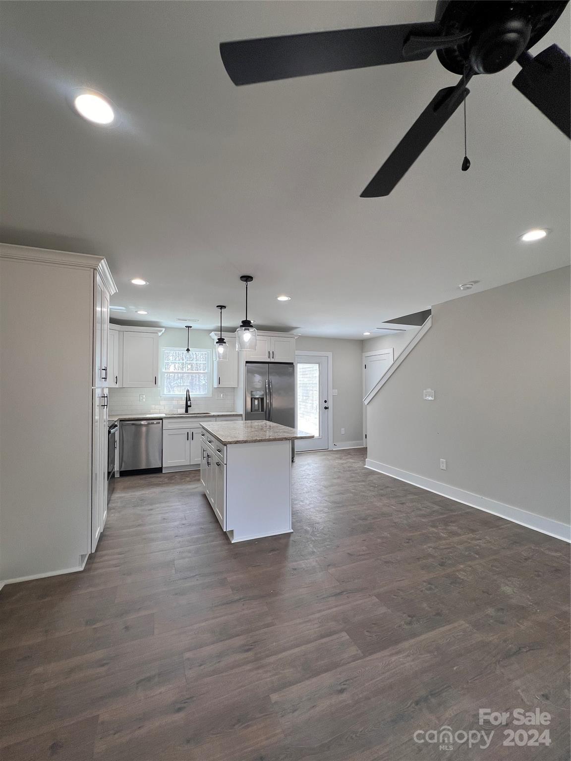 3610 Olive Branch Road Monroe, NC 28110 - Photo 12 of 15 a view of kitchen with kitchen island stainless steel appliances wooden floor and living room view