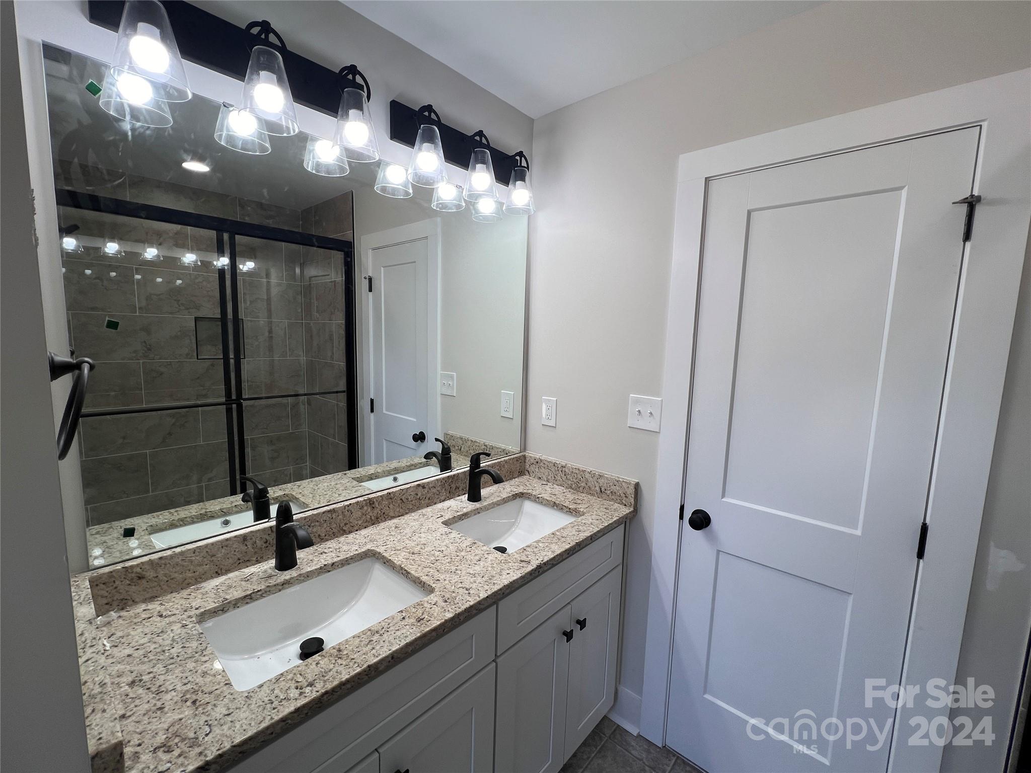 3610 Olive Branch Road Monroe, NC 28110 - Photo 6 of 15 a bathroom with a sink double vanity and a mirror