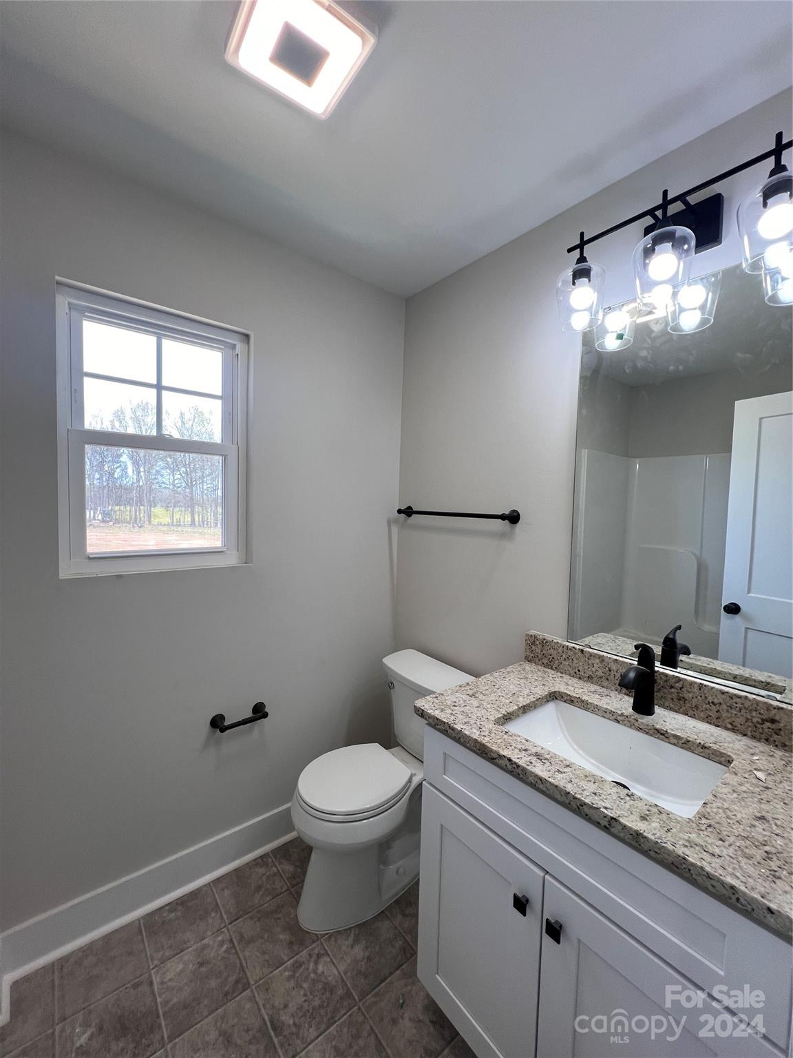 3610 Olive Branch Road Monroe, NC 28110 - Photo 10 of 15 a bathroom with a granite countertop sink a toilet and a mirror
