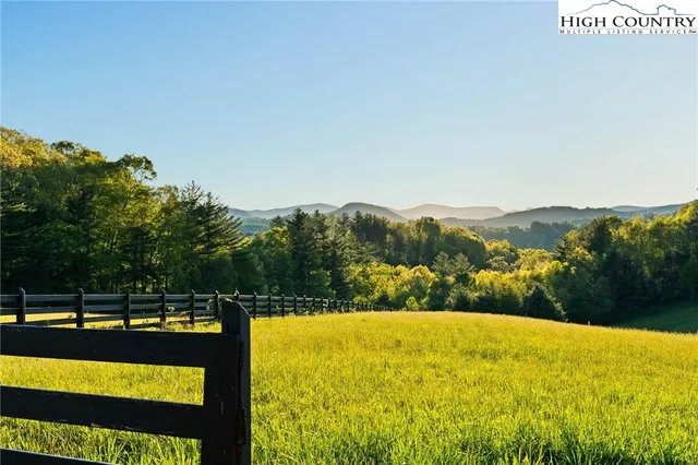 a view of an aerial view of residential houses with outdoor space and trees