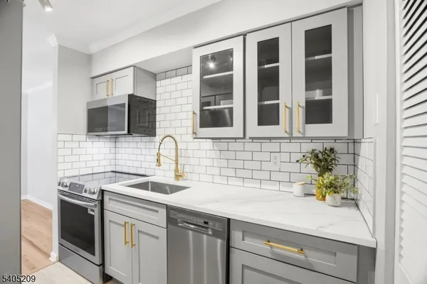 a sink a faucet a window and a potted plant