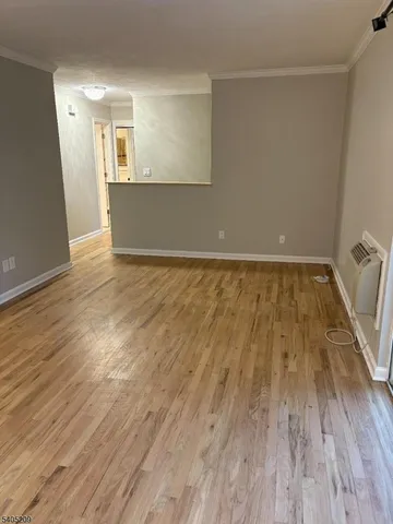 a view of a room with wooden floor and staircase