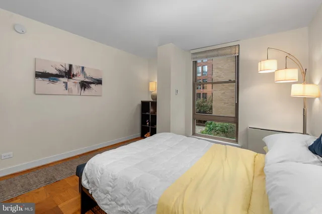 a bedroom with a bed and a painting on the wall