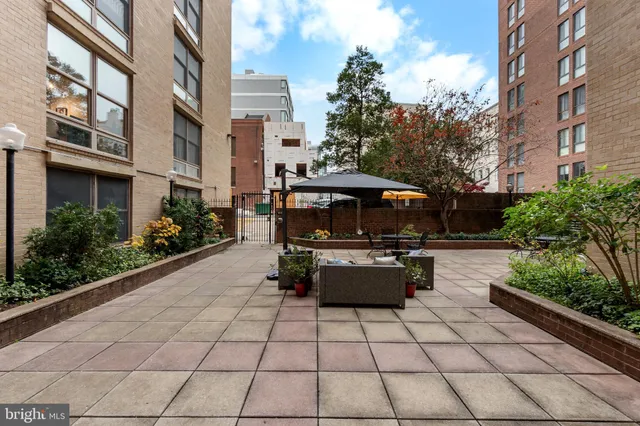 a view of a patio with table and chairs and potted plants