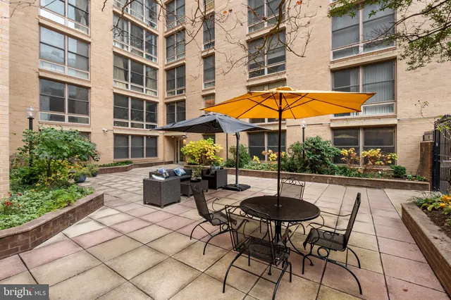 a view of a patio with table and chairs and potted plants