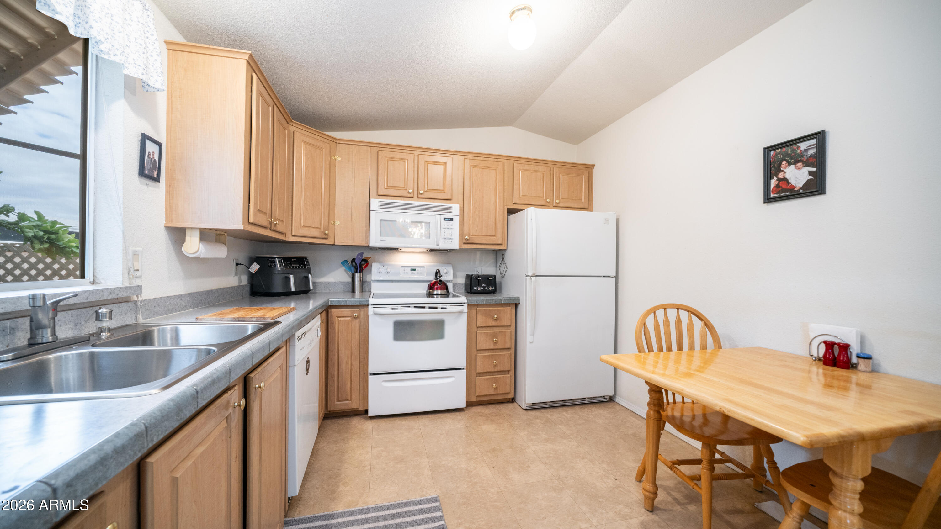 747 East Germann Road, Unit 92 San Tan Valley, AZ 85140 - Photo 11 of 39 a kitchen with a refrigerator a stove a sink dishwasher and white cabinets with wooden floor
