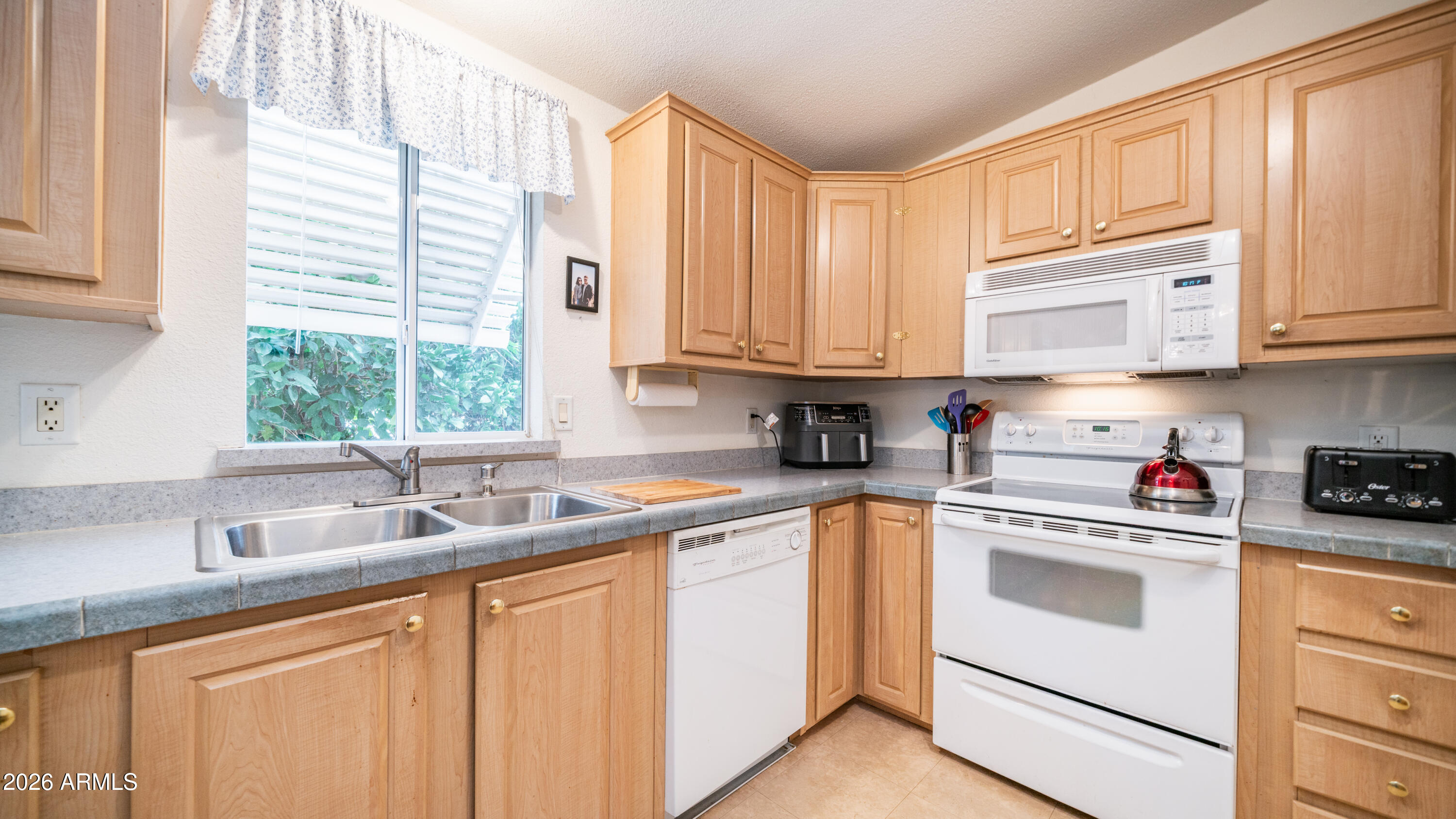 747 East Germann Road, Unit 92 San Tan Valley, AZ 85140 - Photo 12 of 39 a kitchen with white cabinets and white appliances