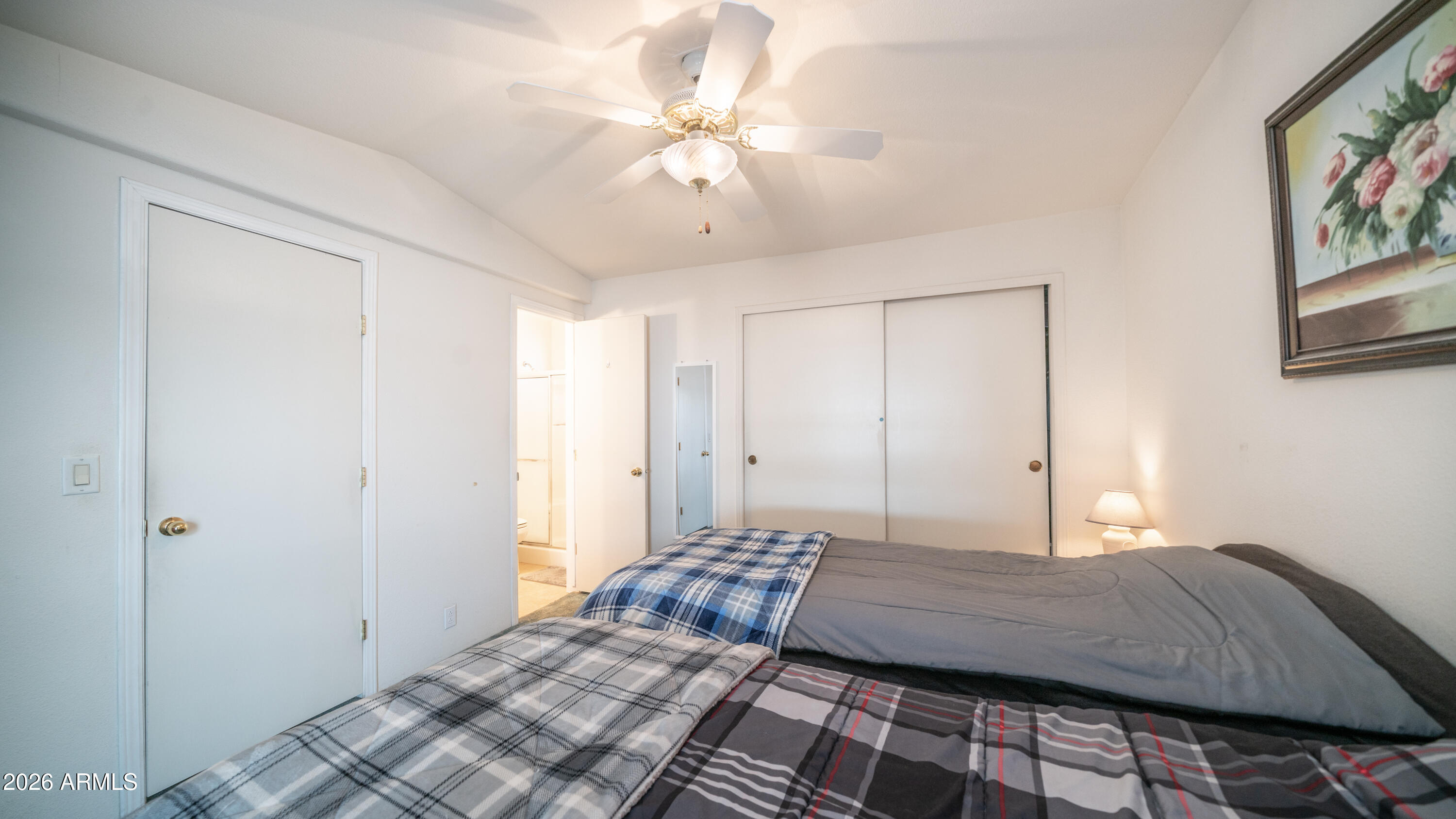 747 East Germann Road, Unit 92 San Tan Valley, AZ 85140 - Photo 16 of 39 a bedroom with a large bed and a chandelier