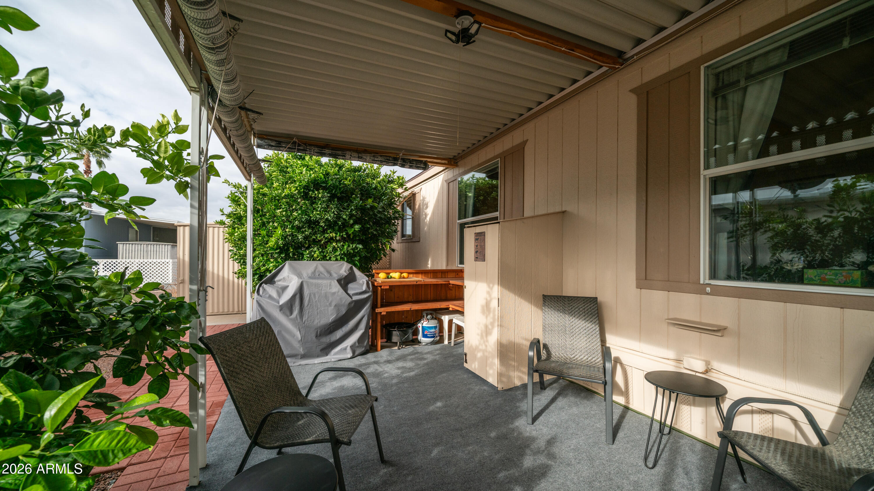 747 East Germann Road, Unit 92 San Tan Valley, AZ 85140 - Photo 25 of 39 a patio with table and chairs and potted plants