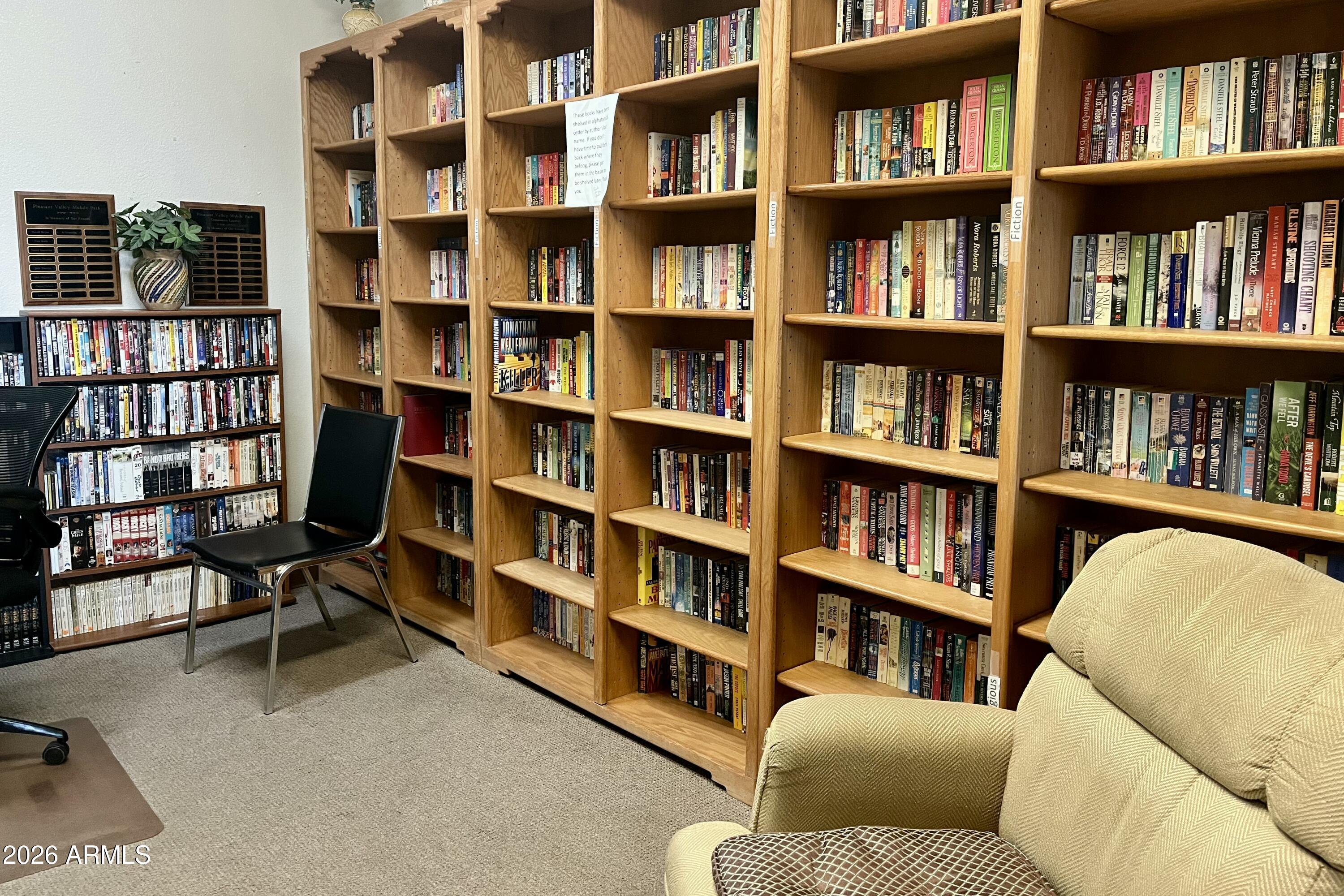 747 East Germann Road, Unit 92 San Tan Valley, AZ 85140 - Photo 38 of 39 a living room with furniture and a book shelf