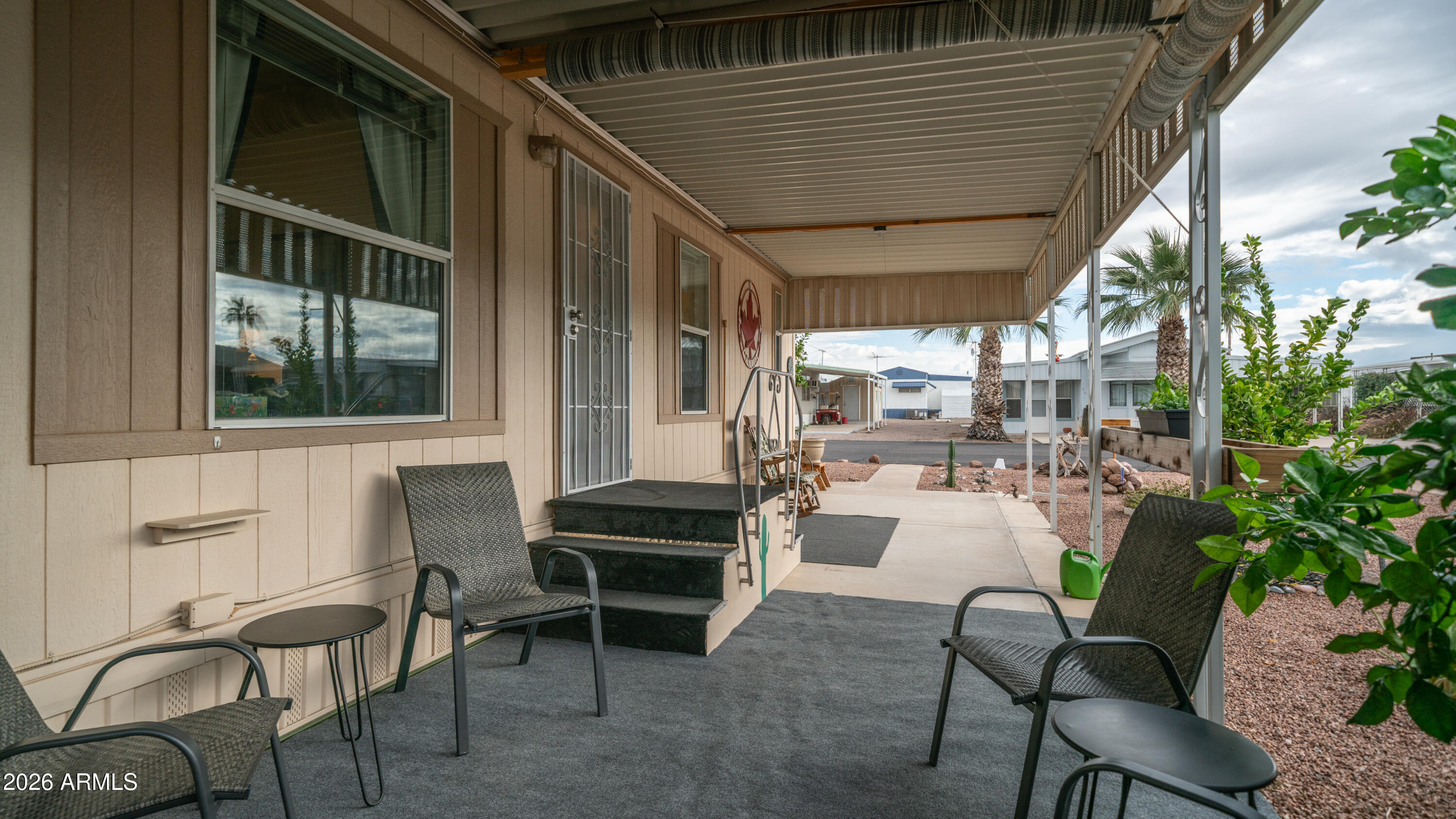 747 East Germann Road, Unit 92 San Tan Valley, AZ 85140 - Photo 5 of 39 a view of a patio with table and chairs and potted plants