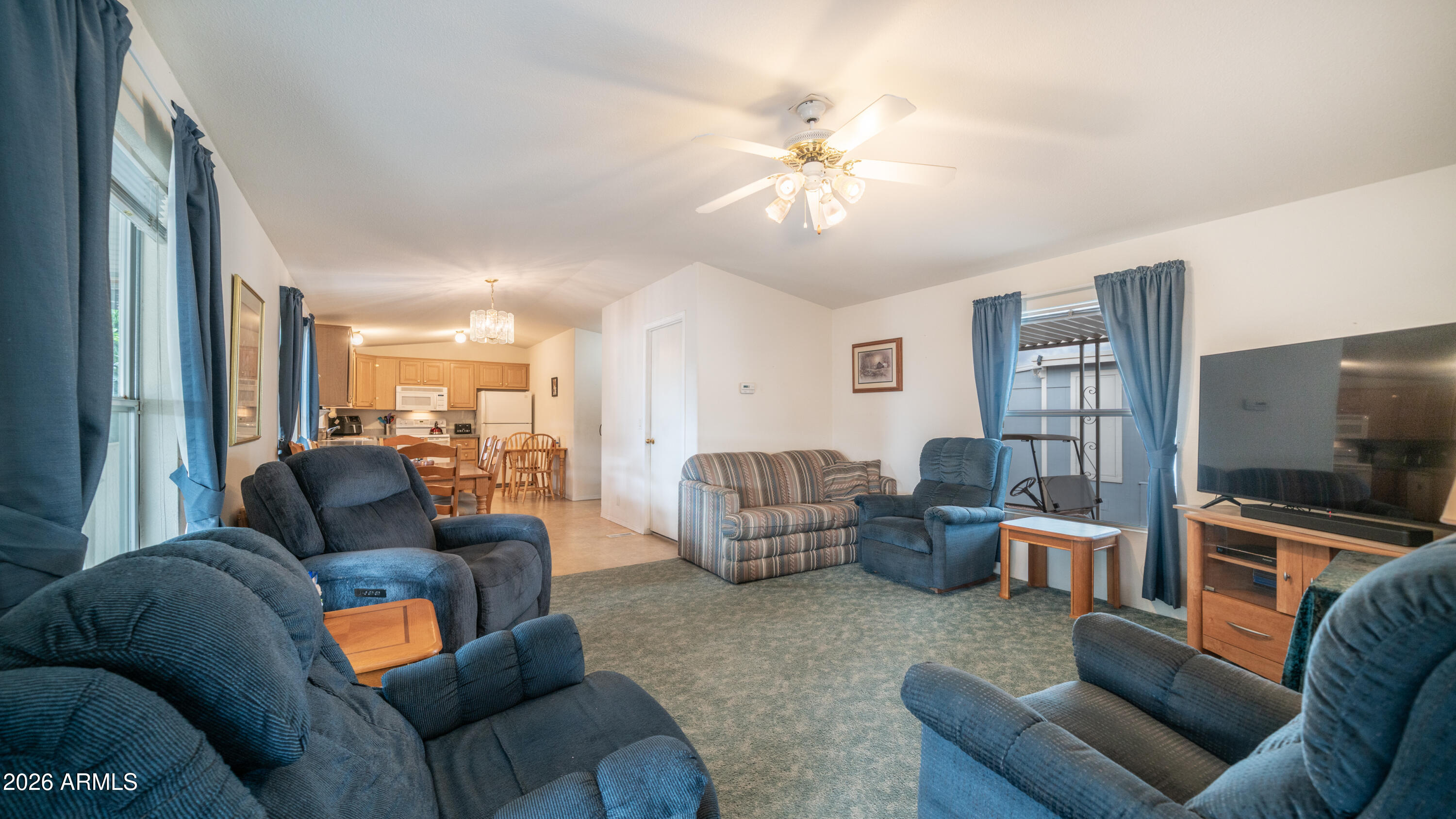 747 East Germann Road, Unit 92 San Tan Valley, AZ 85140 - Photo 7 of 39 a living room with furniture and a flat screen tv