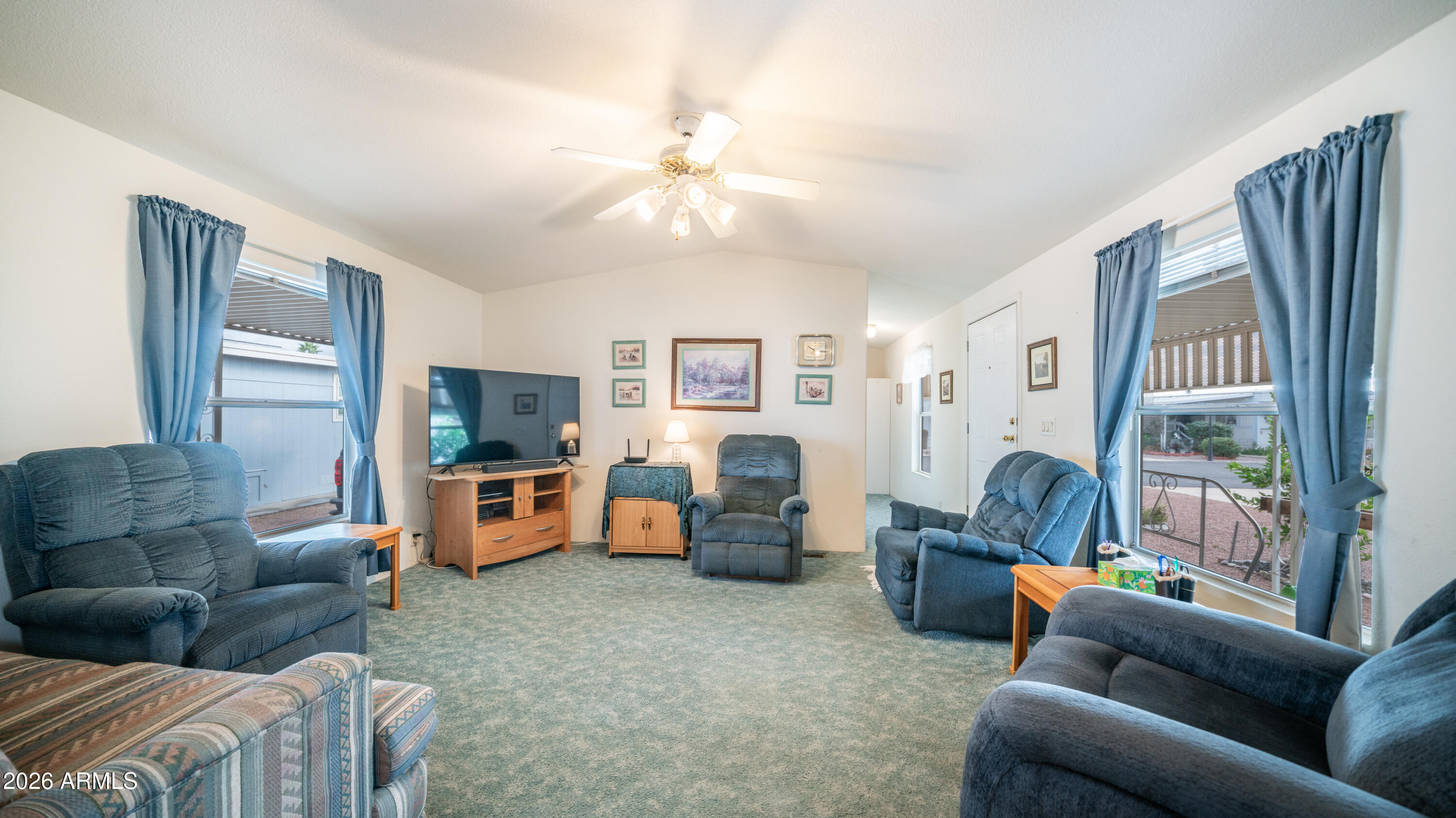 747 East Germann Road, Unit 92 San Tan Valley, AZ 85140 - Photo 8 of 39 a living room with furniture and a flat screen tv