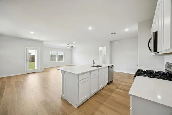 a view of a livingroom with wooden floor and a window