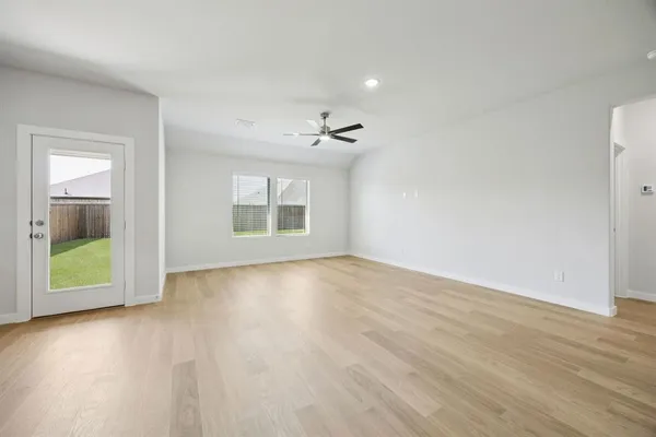 wooden floor in an empty room with a window