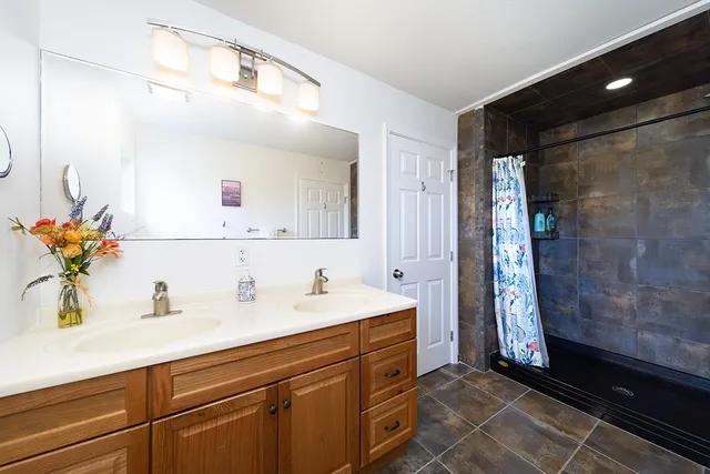 a spacious bedroom with a bed and ceiling fan