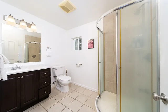 a bedroom with a bed and a ceiling fan