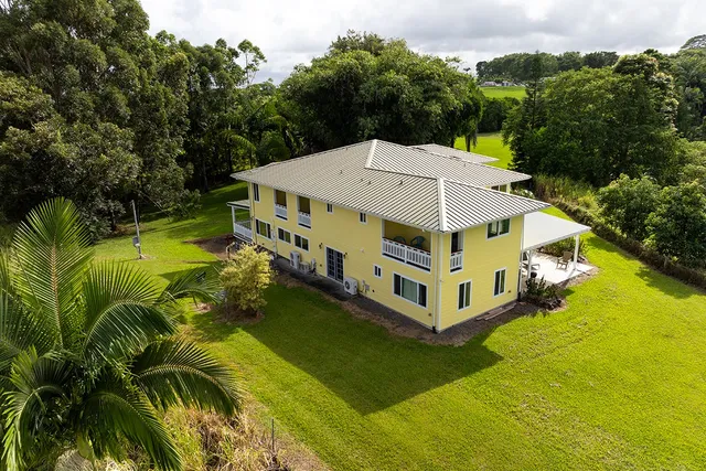 a wooden bench sitting in the middle of a yard