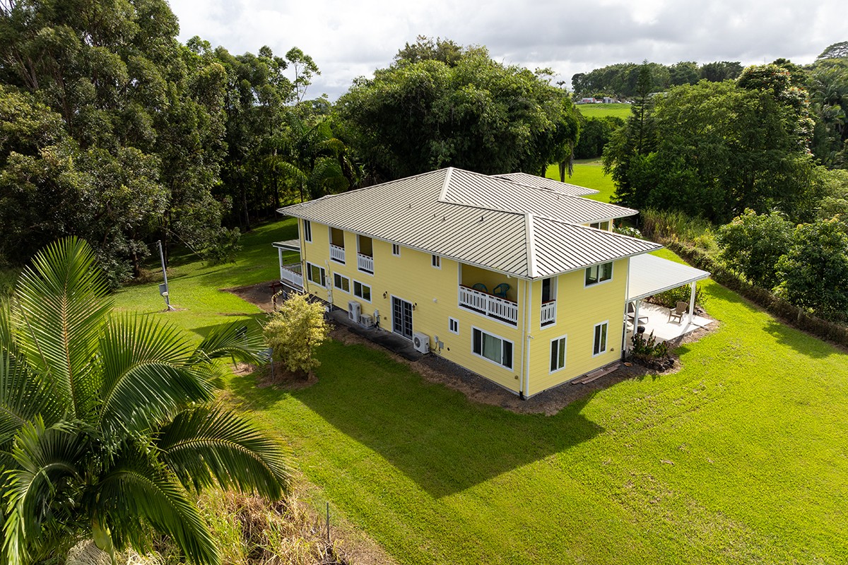 28-380 Sugar Mill Road Pepeekeo, HI 96783 - Photo 26 of 29 a aerial view of a house with swimming pool