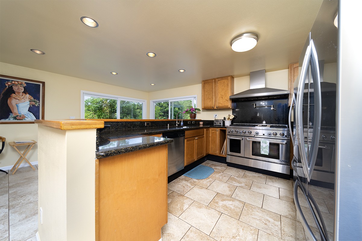 28-380 Sugar Mill Road Pepeekeo, HI 96783 - Photo 8 of 29 a kitchen with stainless steel appliances a stove a sink and a microwave