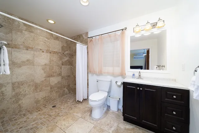 a living room with furniture rug and wooden floor