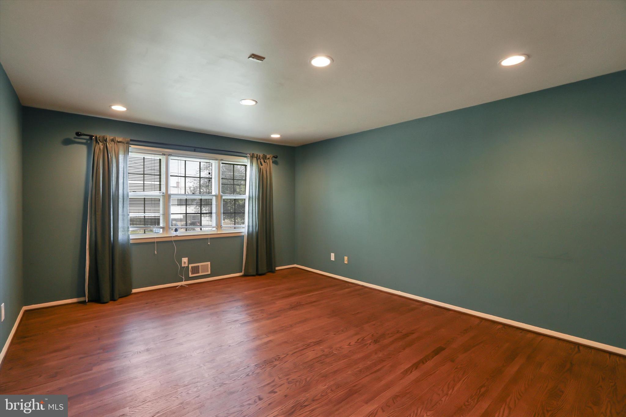 8314 Tinsley Road Baltimore, MD 21244 - Photo 11 of 44 a view of an empty room with wooden floor and a window