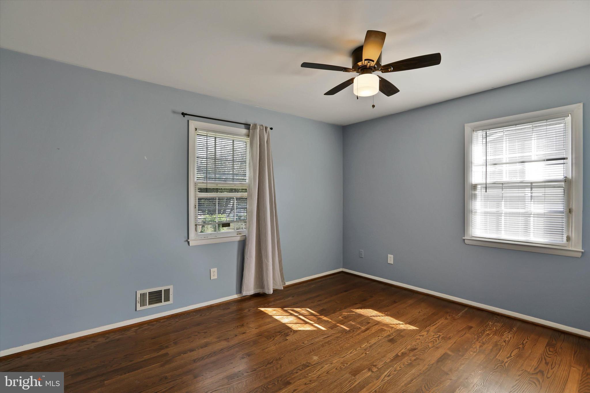 8314 Tinsley Road Baltimore, MD 21244 - Photo 12 of 44 a view of empty room with wooden floor and fan