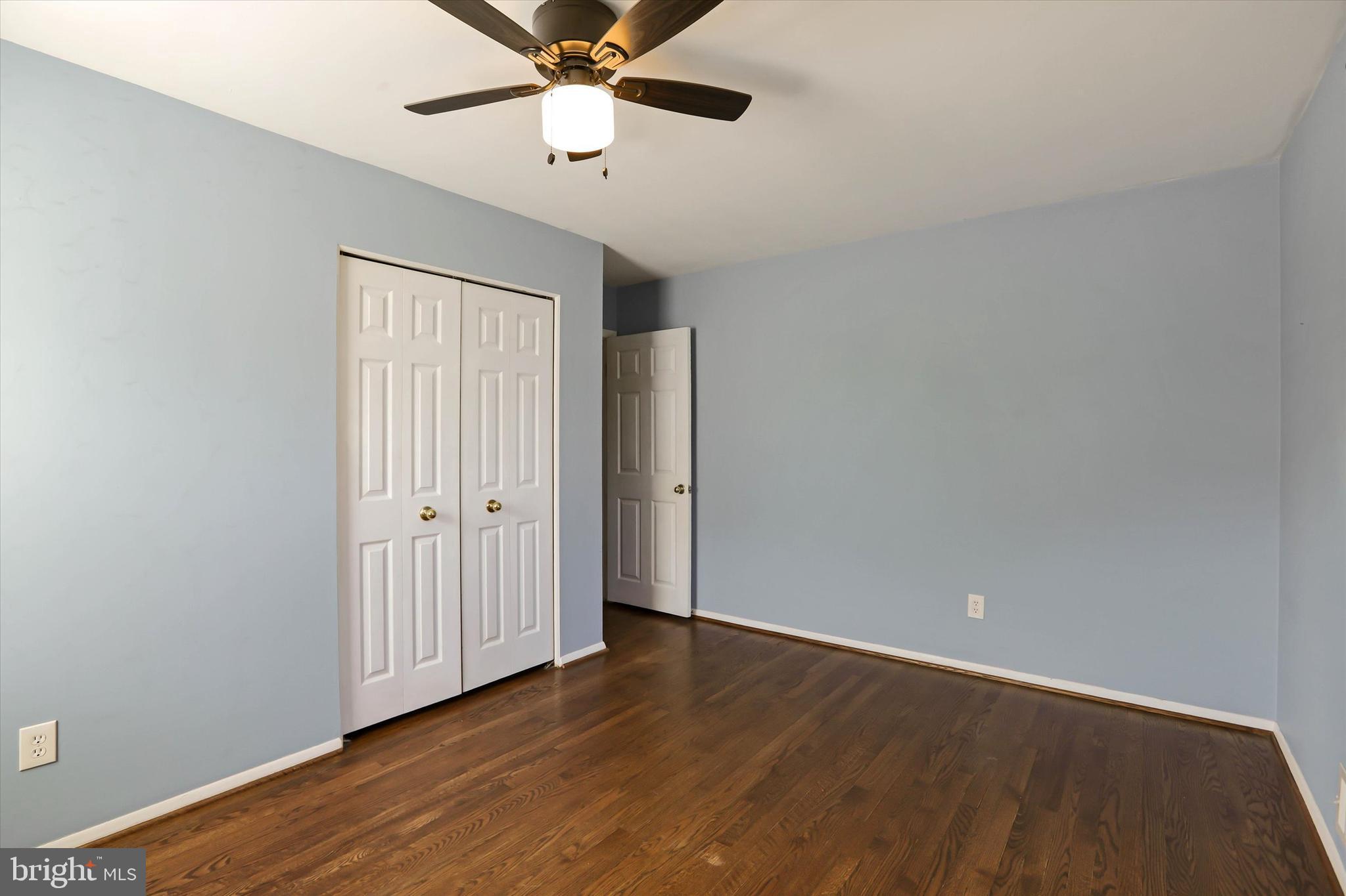 8314 Tinsley Road Baltimore, MD 21244 - Photo 13 of 44 an empty room with wooden floor fan and windows