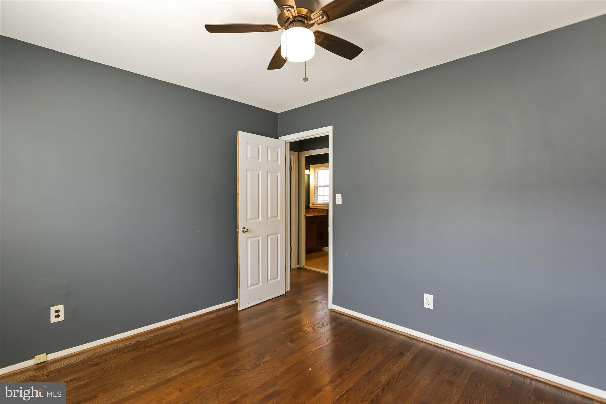 8314 Tinsley Road Baltimore, MD 21244 - Photo 16 of 44 an empty room with wooden floor and fan