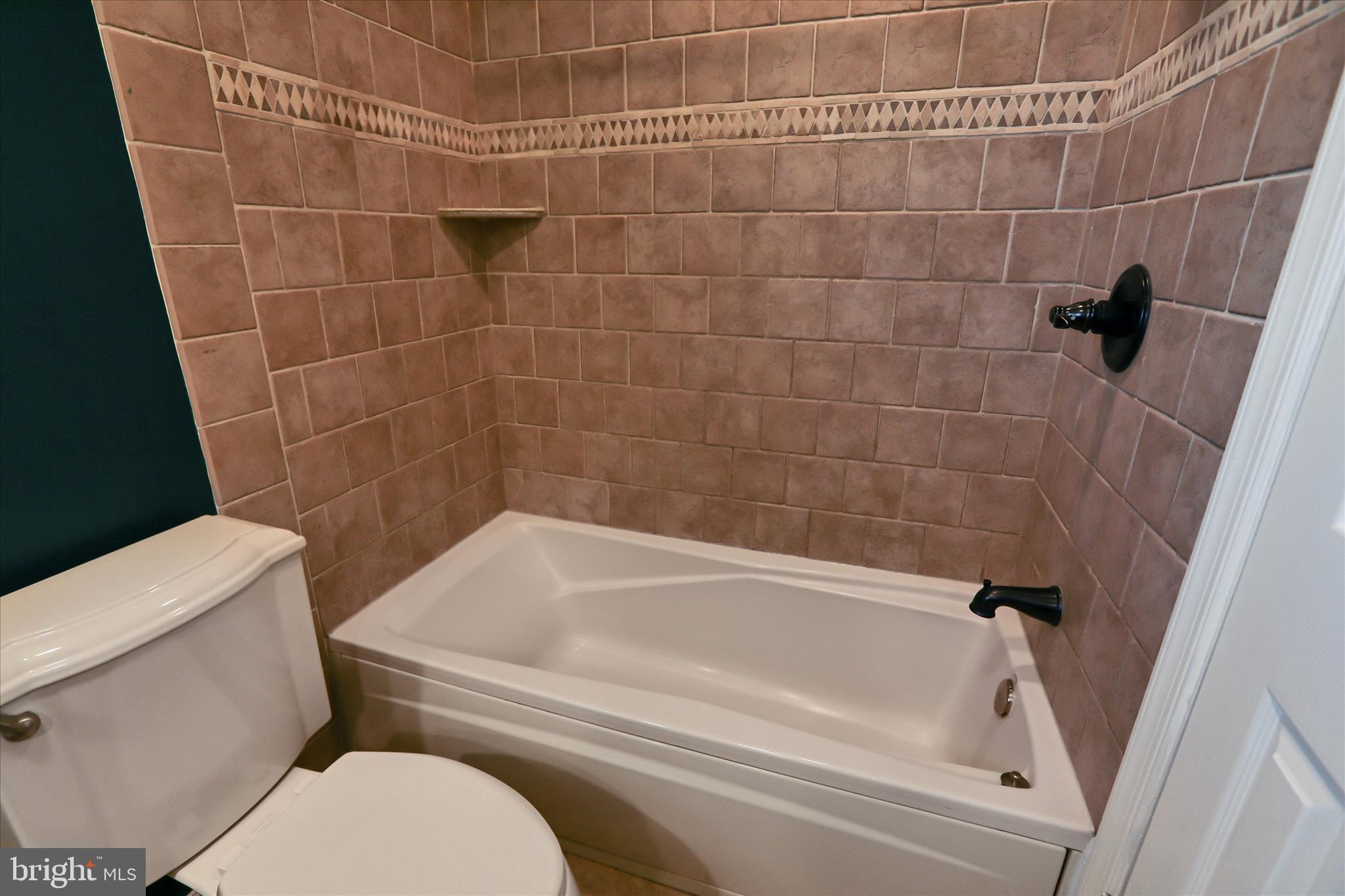 8314 Tinsley Road Baltimore, MD 21244 - Photo 19 of 44 a bathroom with a toilet and bathtub