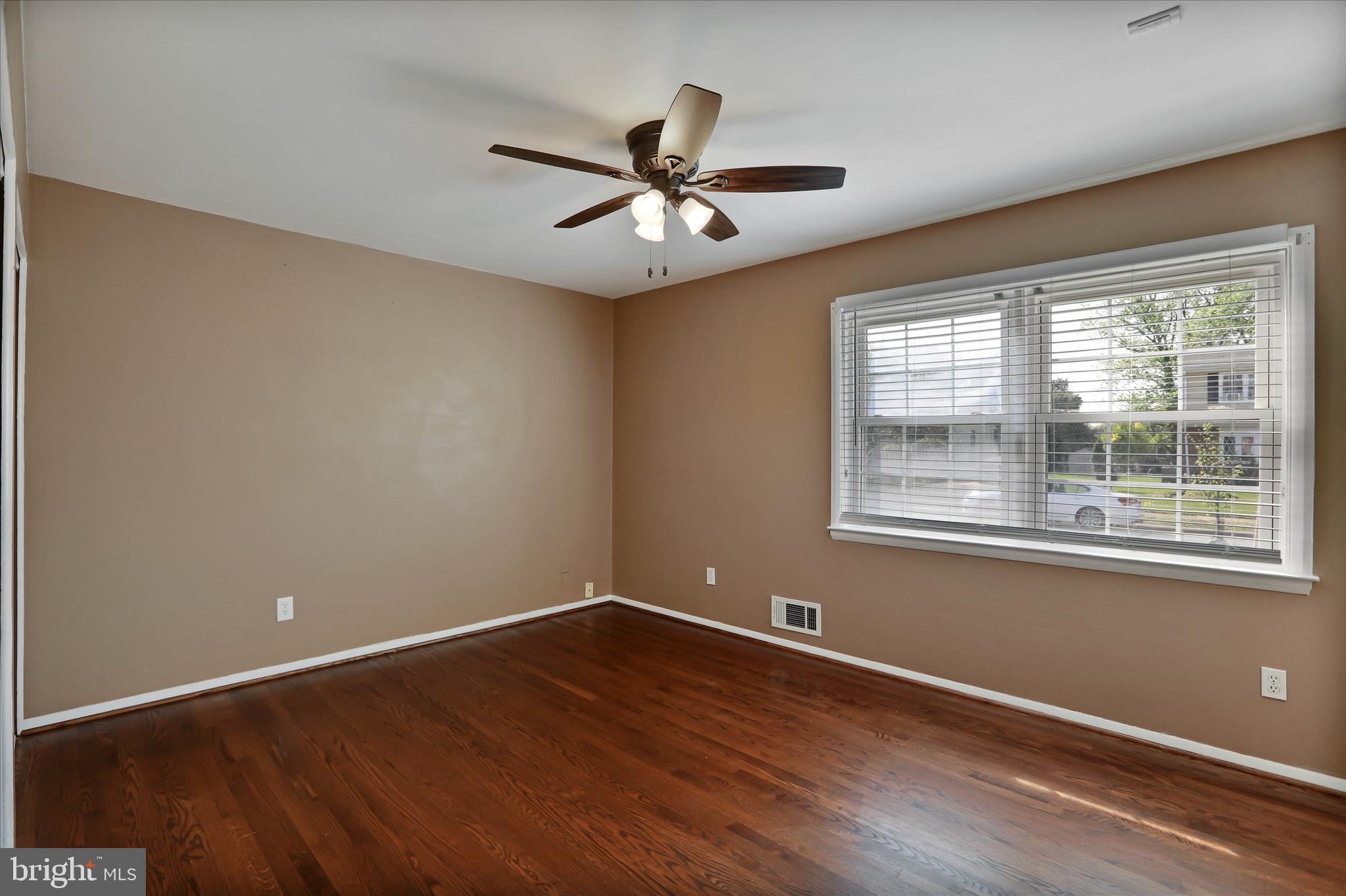8314 Tinsley Road Baltimore, MD 21244 - Photo 20 of 44 an empty room with wooden floor fan and windows