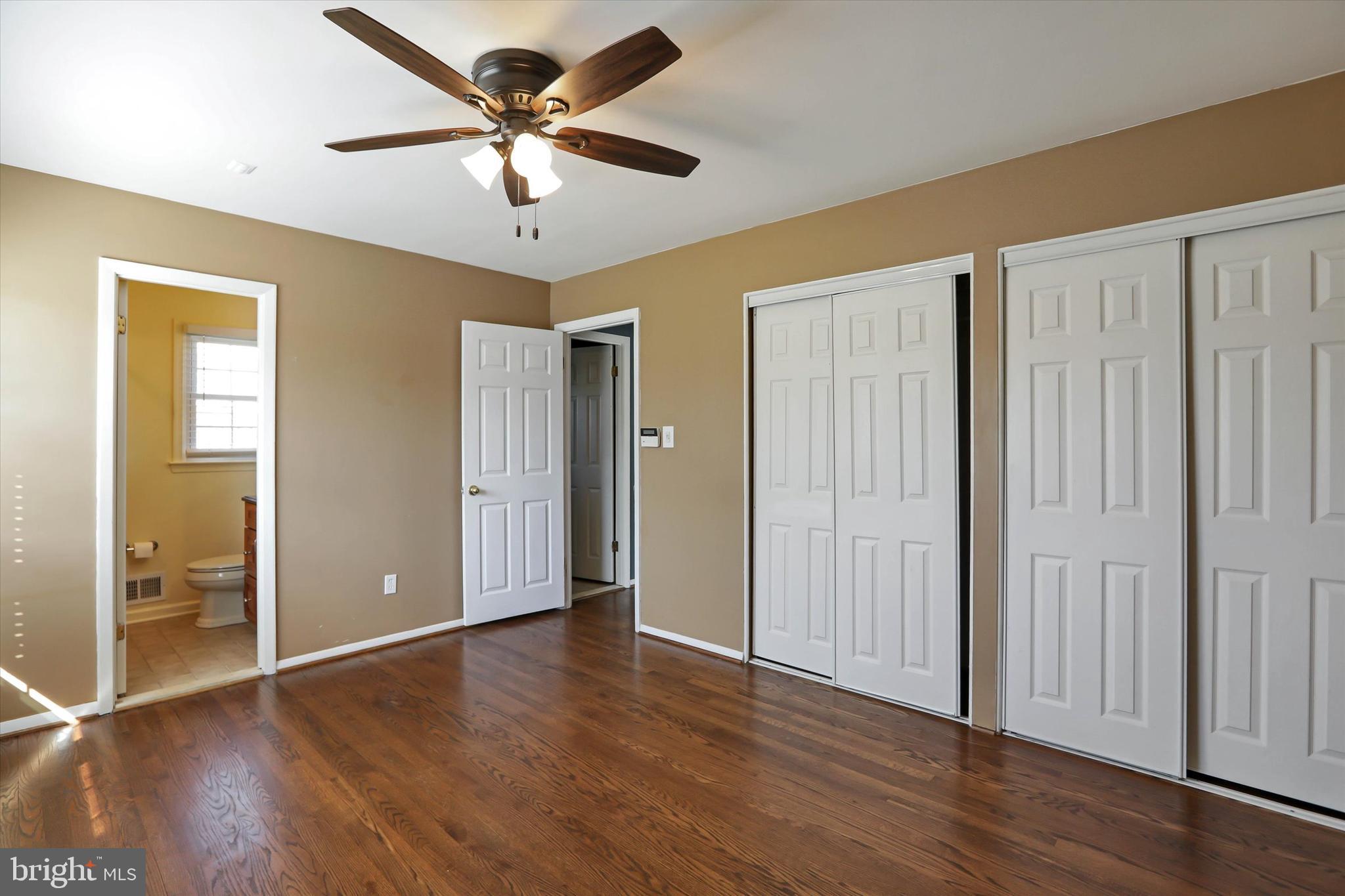 8314 Tinsley Road Baltimore, MD 21244 - Photo 21 of 44 an empty room with wooden floor and a ceiling fan