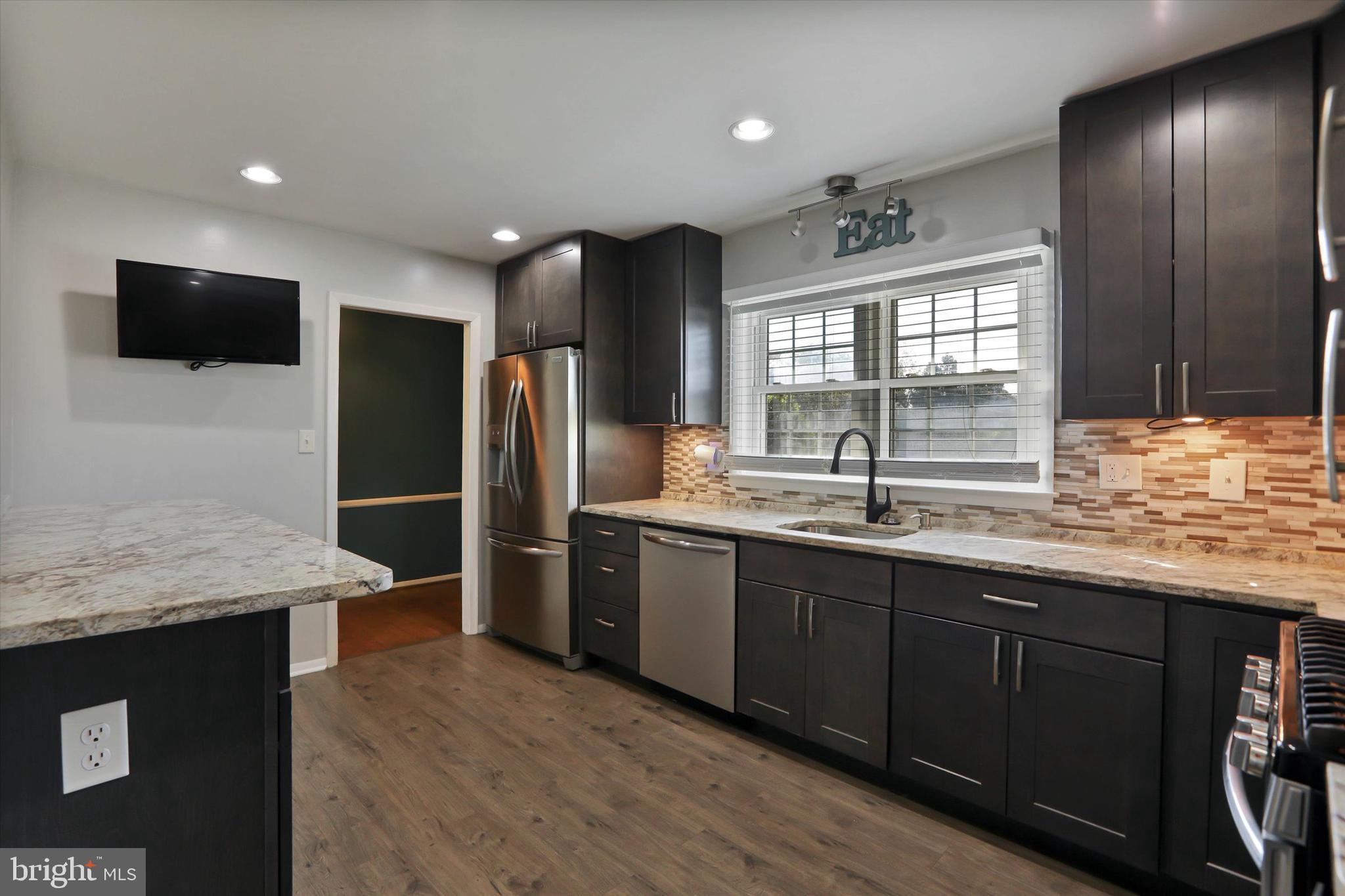 8314 Tinsley Road Baltimore, MD 21244 - Photo 7 of 44 a kitchen with stainless steel appliances granite countertop a sink stove and refrigerator