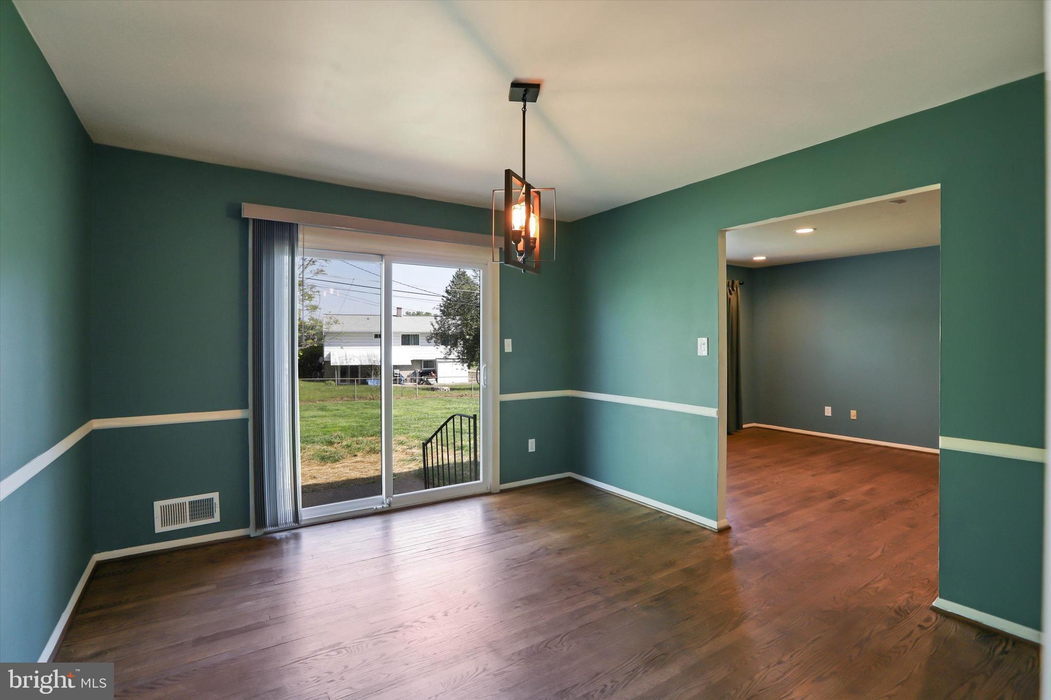 8314 Tinsley Road Baltimore, MD 21244 - Photo 8 of 44 a view of a room with wooden floor and sliding door