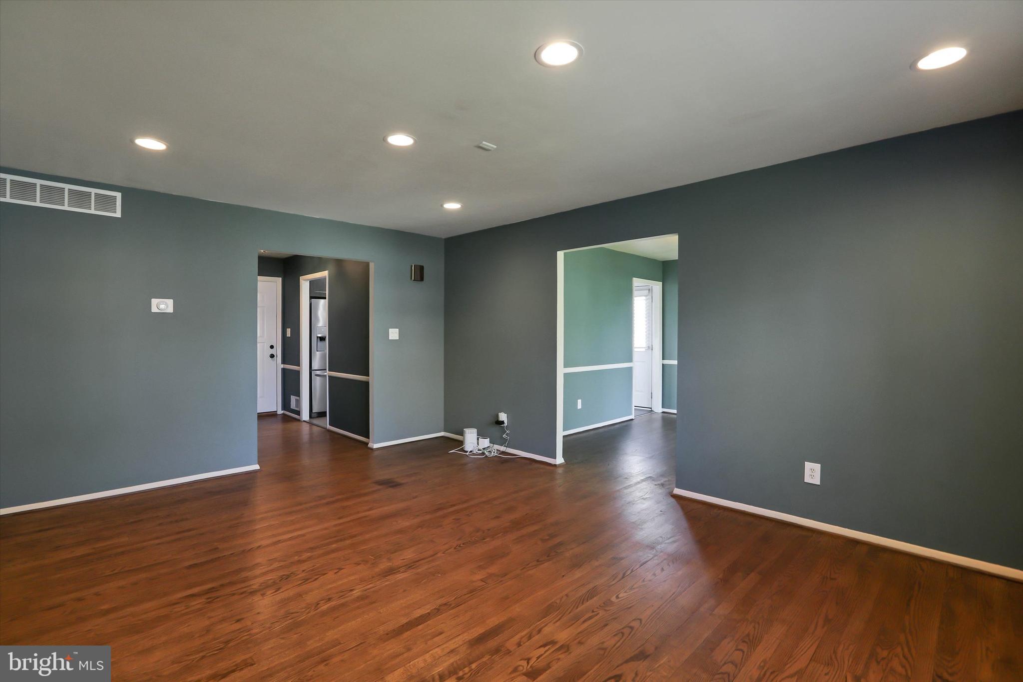 8314 Tinsley Road Baltimore, MD 21244 - Photo 10 of 44 a view of an empty room with wooden floor and a window