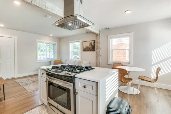 a kitchen that has a stove and a table