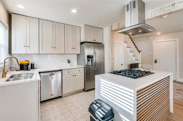 a kitchen with stainless steel appliances granite countertop a sink stove and refrigerator