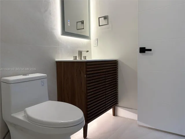 a bathroom with a toilet and shower