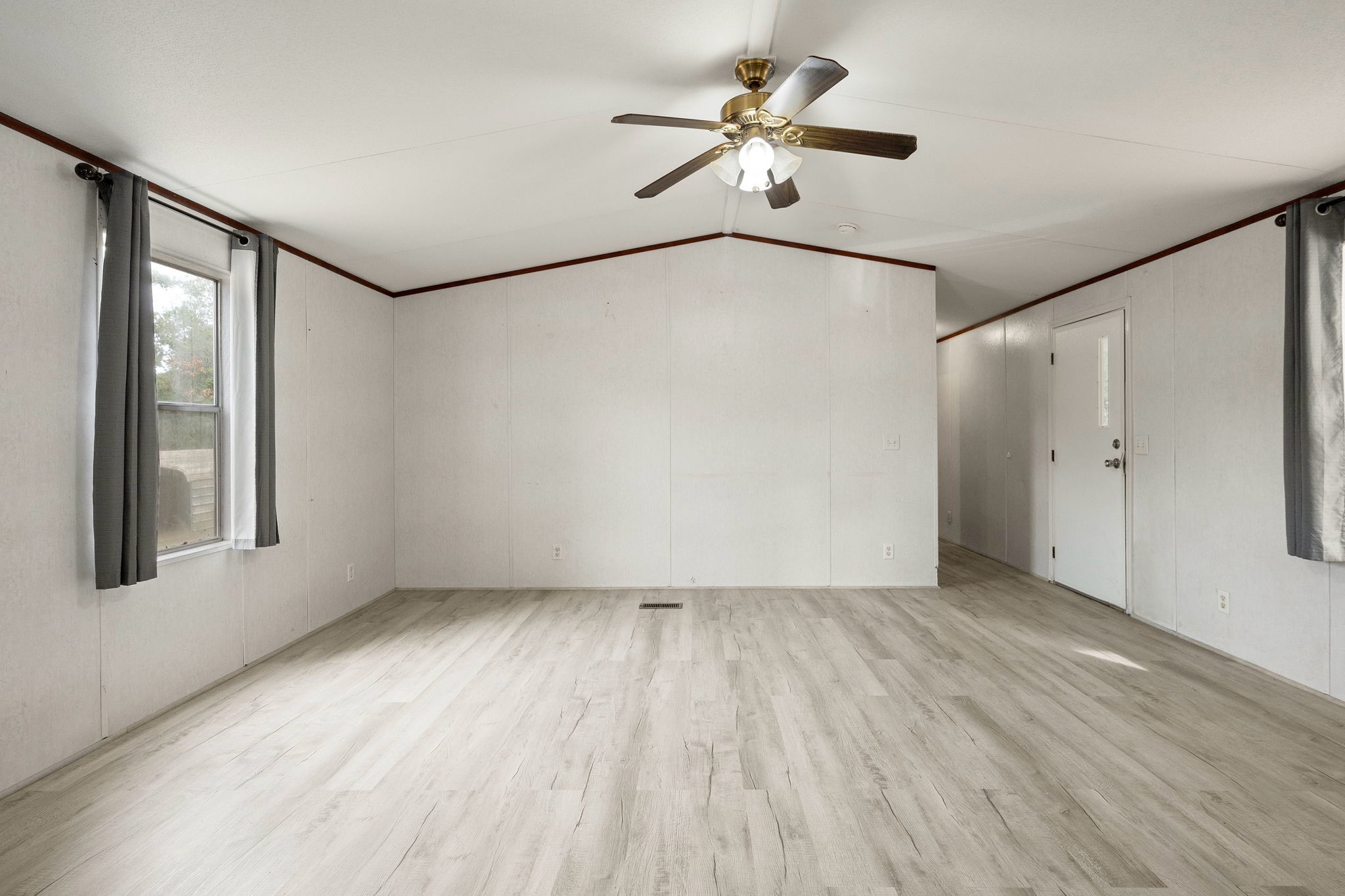 6493 Pappas Road Waller, TX 77484 - Photo 11 of 28 Open-concept living room with abundant natural light, designed for functional everyday living on a private parcel.